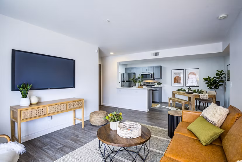 Stylish living room with large windows and modern decor at Lumen Apartments