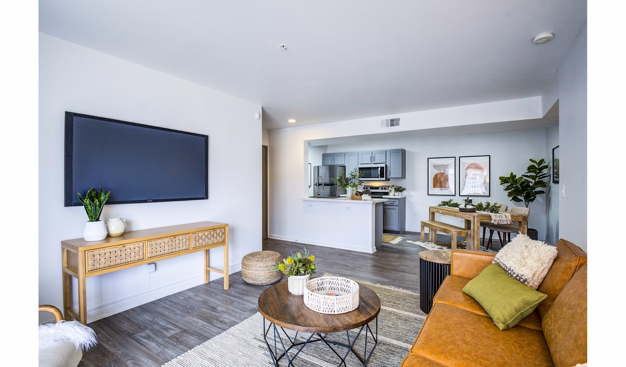 Stylish living room with large windows and modern decor at Lumen Apartments