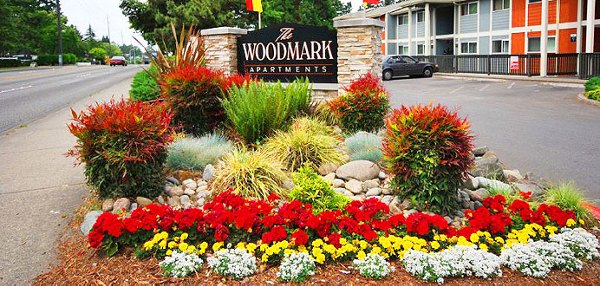 Entrance signage at The Woodmark Apartments, showcasing luxury living with modern design in a prime location