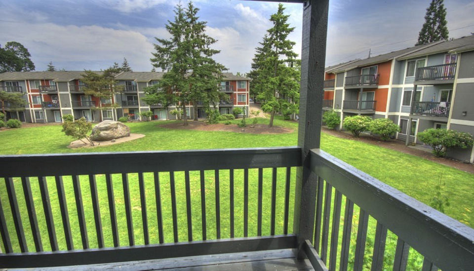 Spacious outdoor patio with modern seating at The Woodmark Apartments