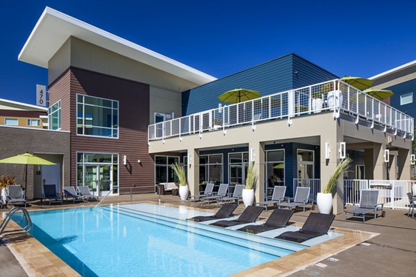 Riverside pool with lounge chairs at Riverwalk Apartments