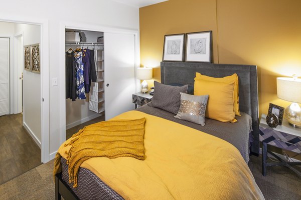 Modern bedroom with stylish decor at Riverwalk Apartments