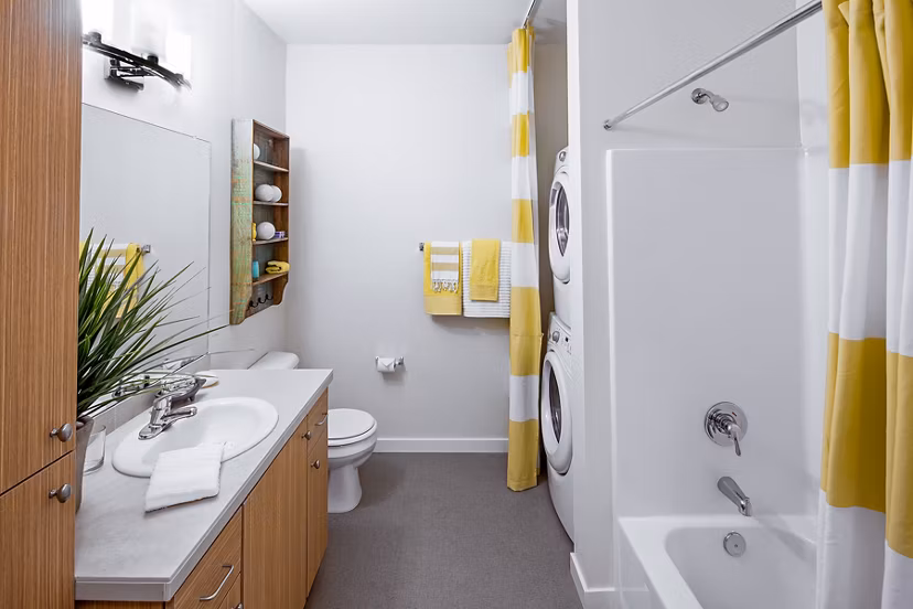 Bathroom with elegant marble countertops and modern fixtures at Riverwalk Apartments, a Greystar luxury apartment community