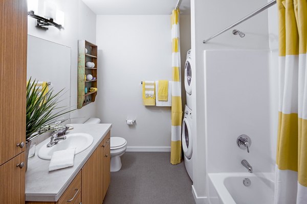 Bathroom with elegant marble countertops and modern fixtures at Riverwalk Apartments, a Greystar luxury apartment community