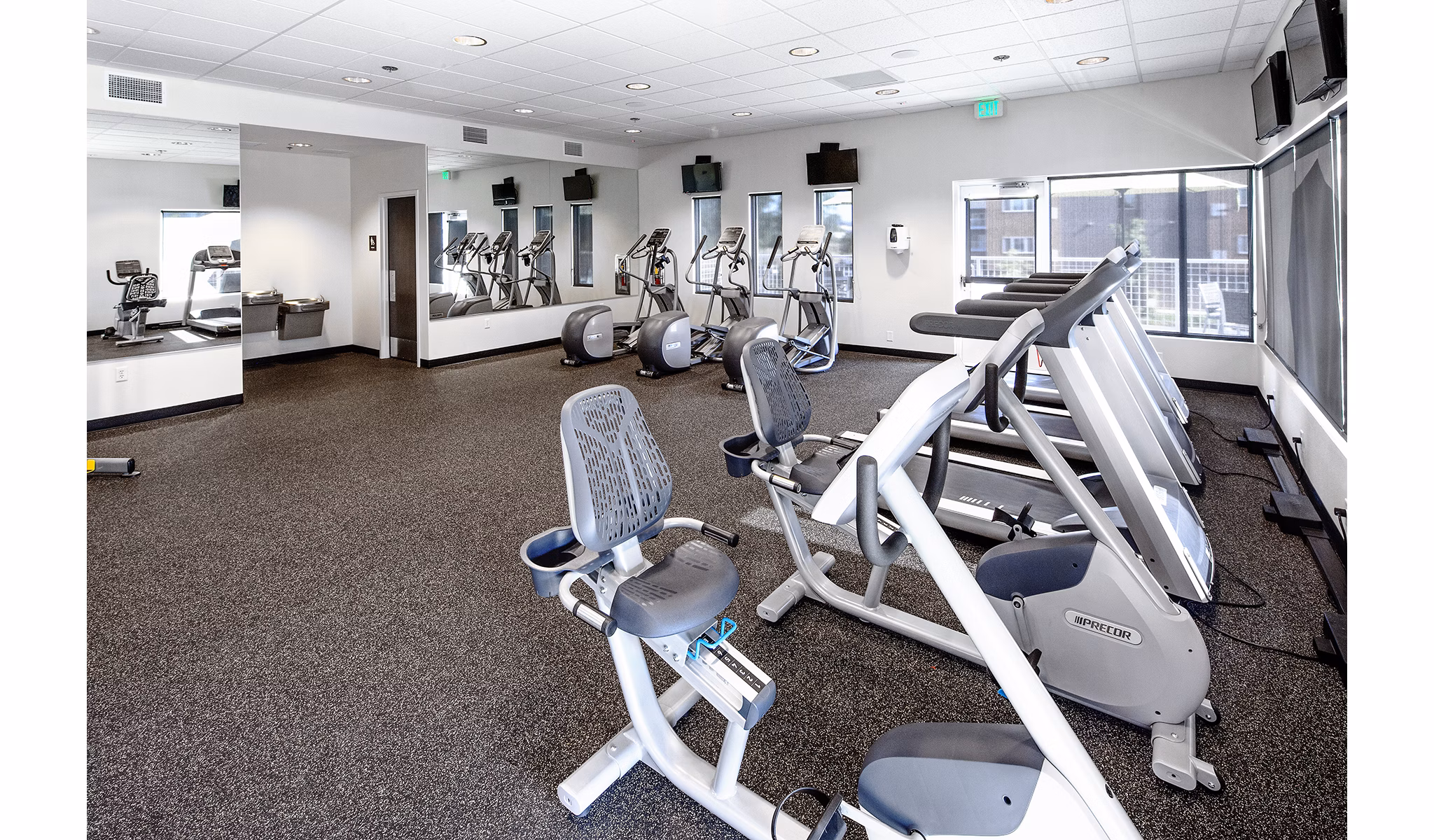 State-of-the-art fitness center with modern equipment at Riverwalk Apartments in a serene riverside setting