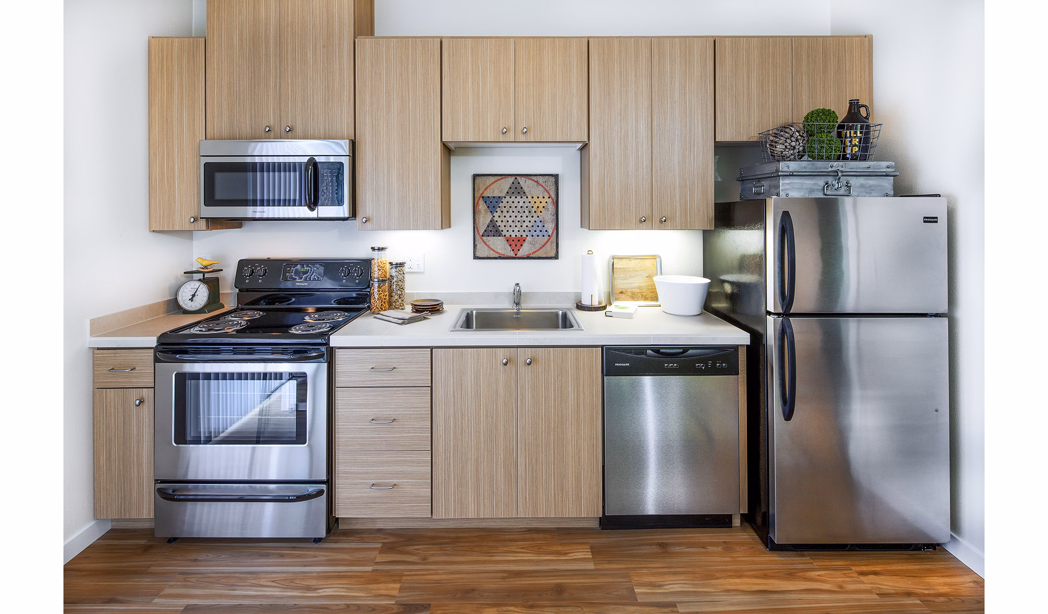 Modern kitchen with stainless steel appliances in Riverwalk Apartments, luxury living spaces by Greystar
