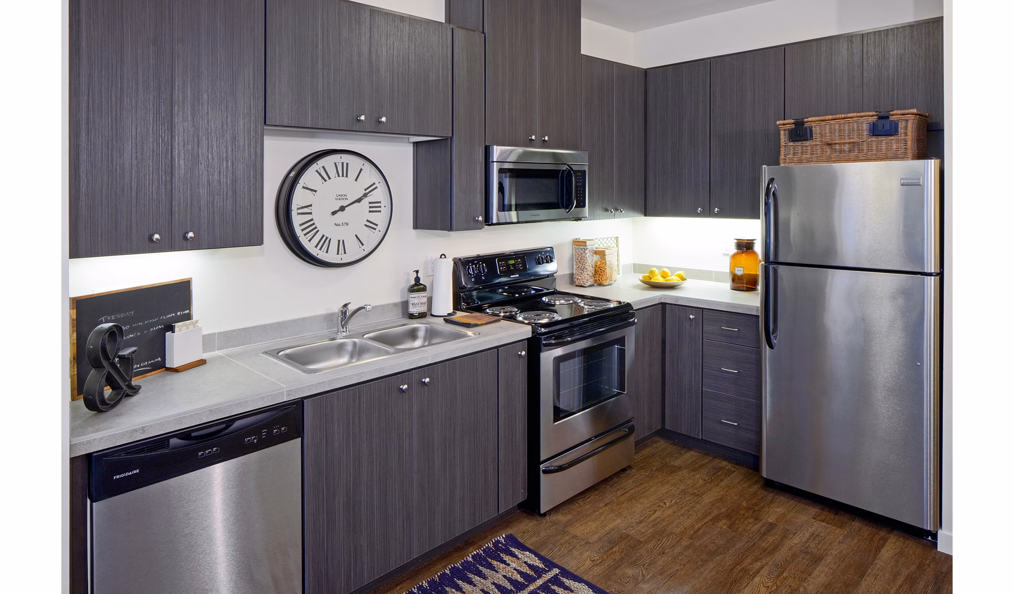 Modern kitchen featuring stainless steel appliances at Riverwalk Apartments