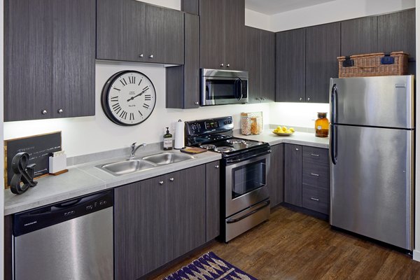 Modern kitchen featuring stainless steel appliances at Riverwalk Apartments