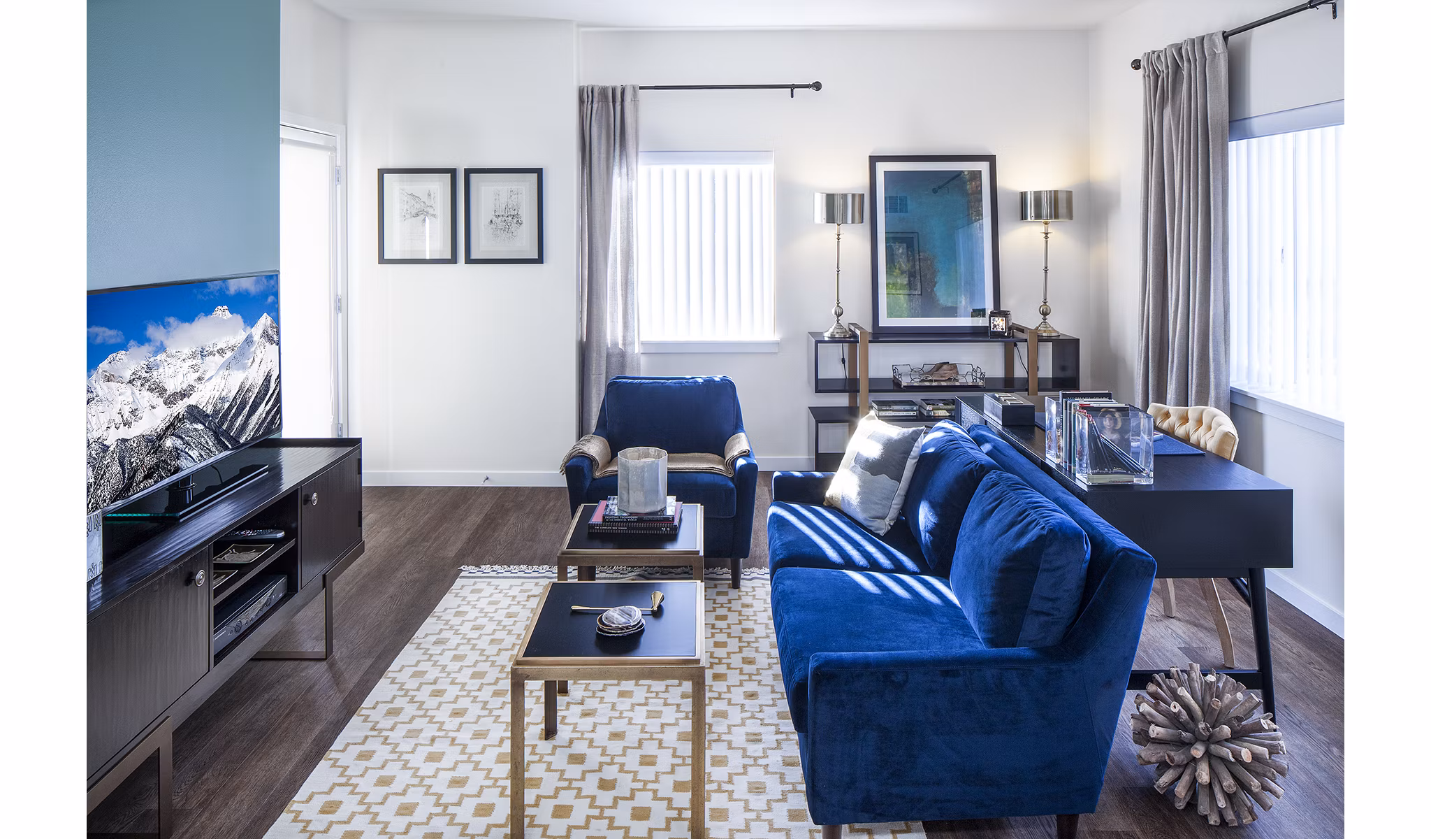 Spacious living room with modern decor in Riverwalk Apartments, offering luxury living with abundant natural light and stylish furnishings