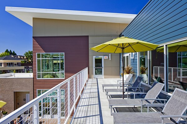 Patio with outdoor seating and scenic river views at Riverwalk Apartments