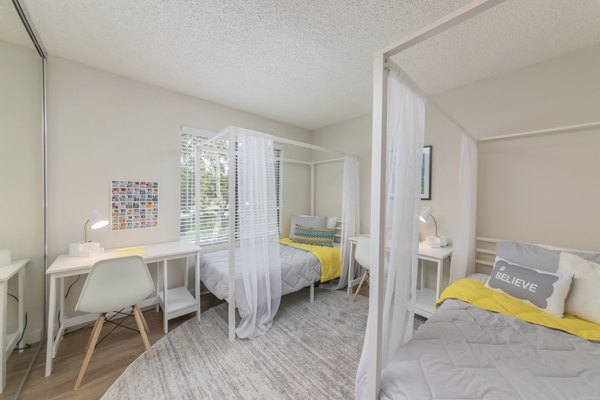 The Hilltop Apartments: Cozy bedroom with modern decor and ample natural light, perfect for luxurious living