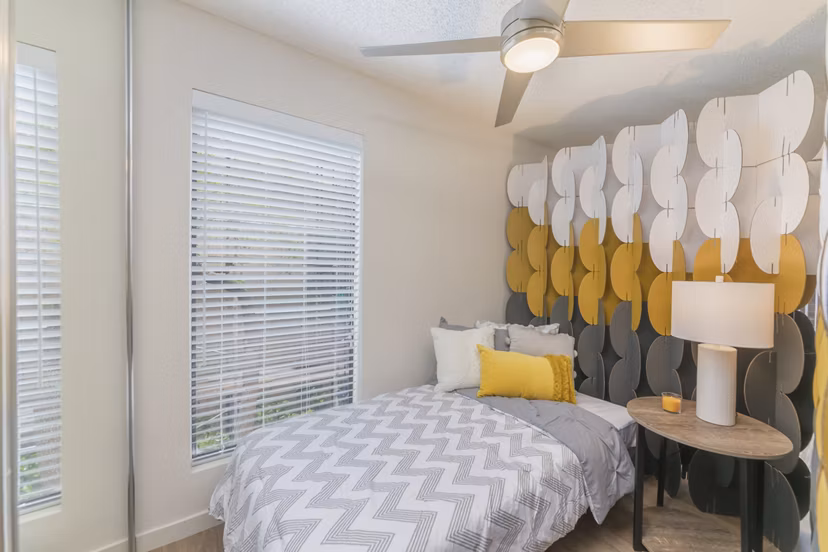 The Hilltop Apartments: Cozy bedroom with modern furnishings and city views