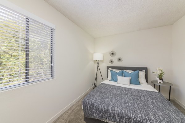 Elegant bedroom with modern decor at The Hilltop Apartments