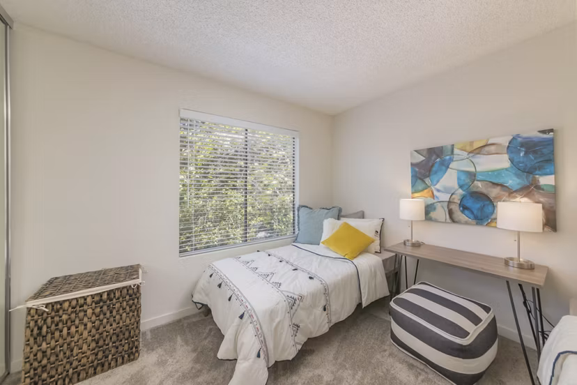 The Hilltop Apartments: Cozy bedroom with modern furnishings and natural light