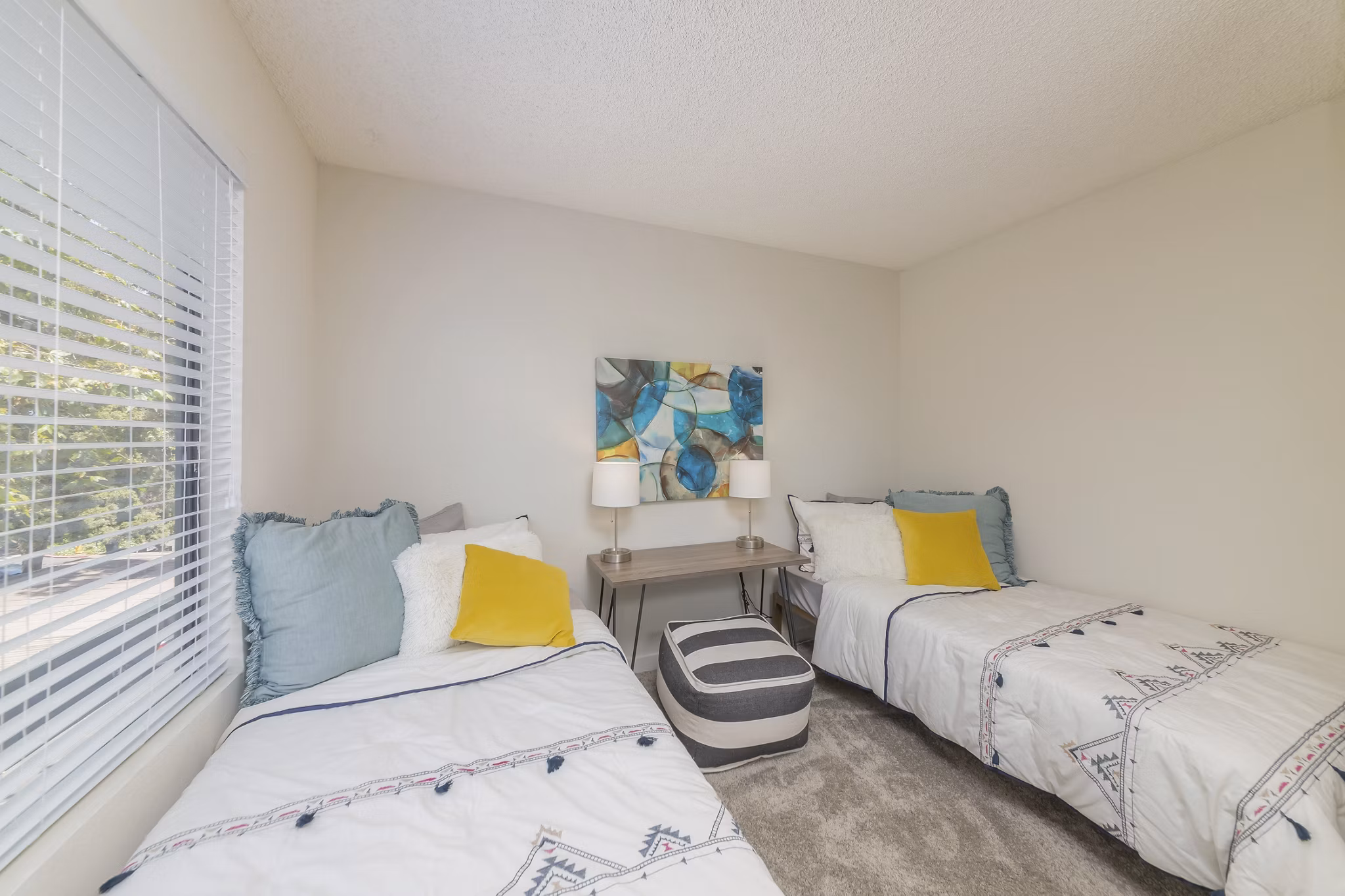 Spacious bedroom with modern furnishings at The Hilltop Apartments