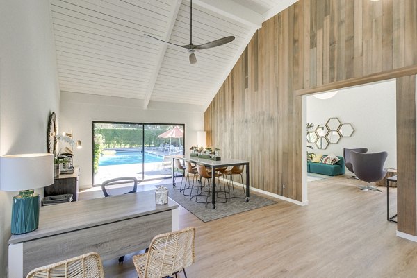The Hilltop Apartments: Modern clubhouse featuring stylish seating and entertainment areas