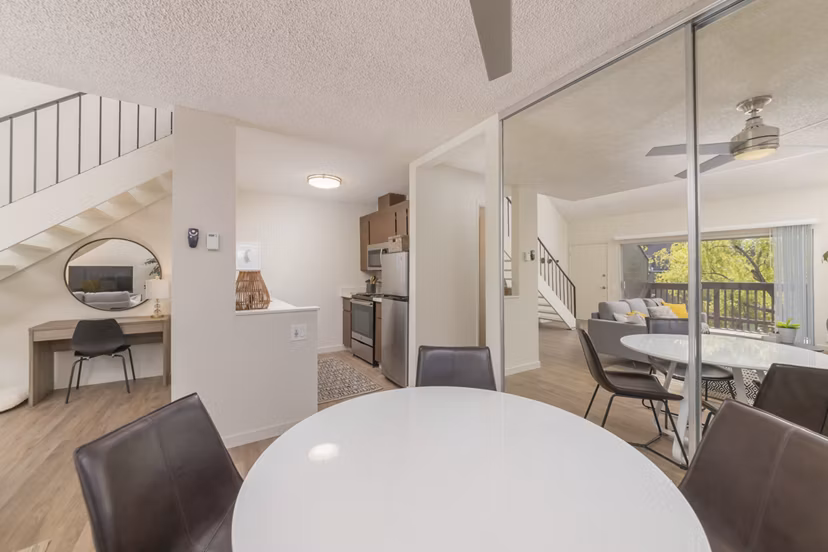Dining area featuring modern decor and large windows at The Hilltop Apartments, a luxurious Greystar community