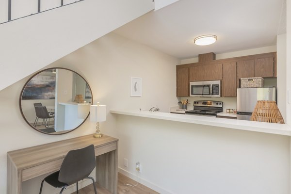 Modern kitchen with stainless steel appliances at The Hilltop Apartments