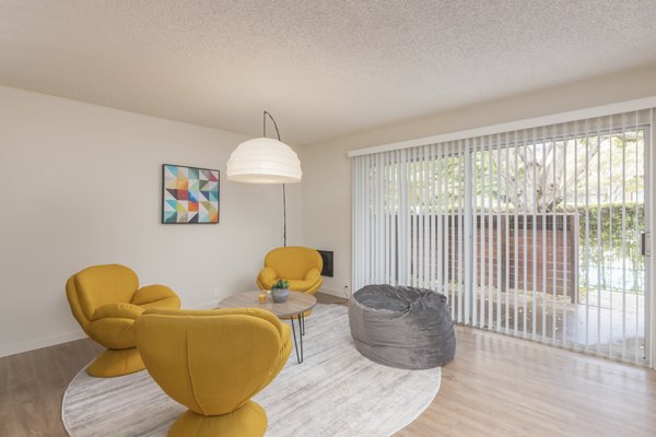 Living room with modern decor and open layout in The Hilltop Apartments, a Greystar luxury property