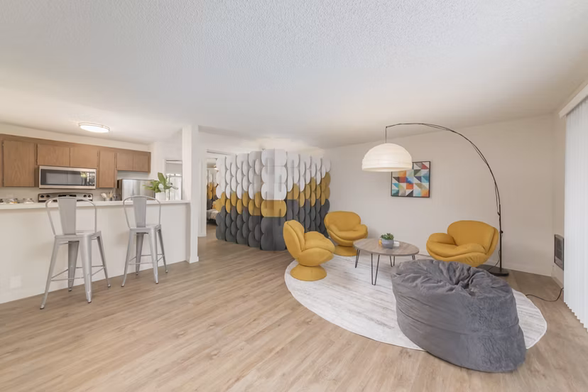 Spacious living room with contemporary furnishings at The Hilltop Apartments