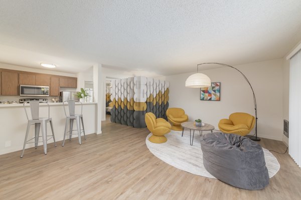 Spacious living room with contemporary furnishings at The Hilltop Apartments