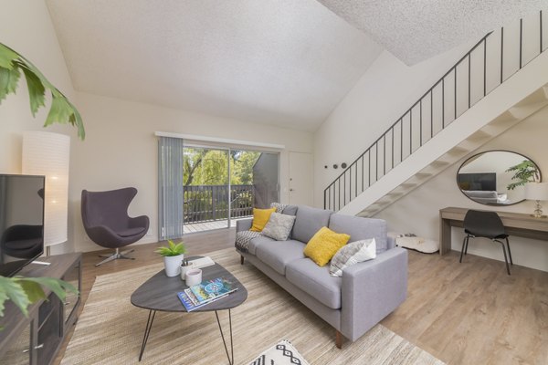 Spacious living room with elegant decor and natural light at The Hilltop Apartments, a Greystar luxury property