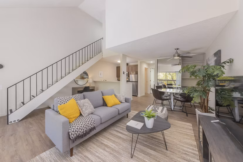 Spacious living room with modern decor and large windows in The Hilltop Apartments