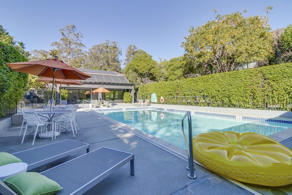 Inviting outdoor pool with lounge seating at The Hilltop Apartments, a luxury Greystar community