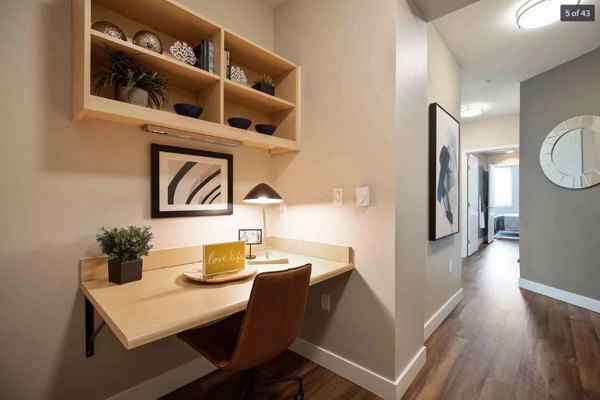 Contemporary home office with ergonomic chair and large desk in The Pacifica Apartments