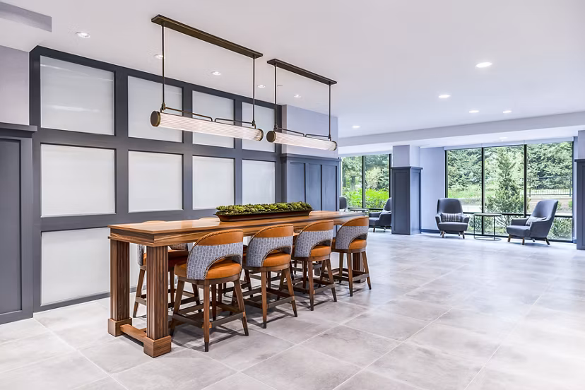 Modern lobby with stylish seating and lighting in Delwyn Apartments clubhouse
