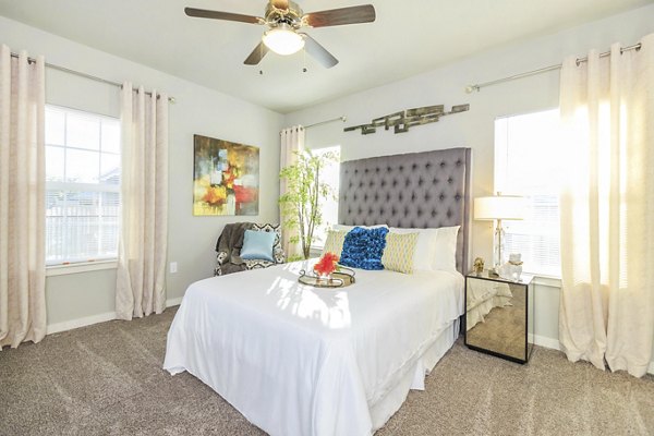 Bedroom featuring plush bedding and modern decor in Vantage at Boerne Apartments