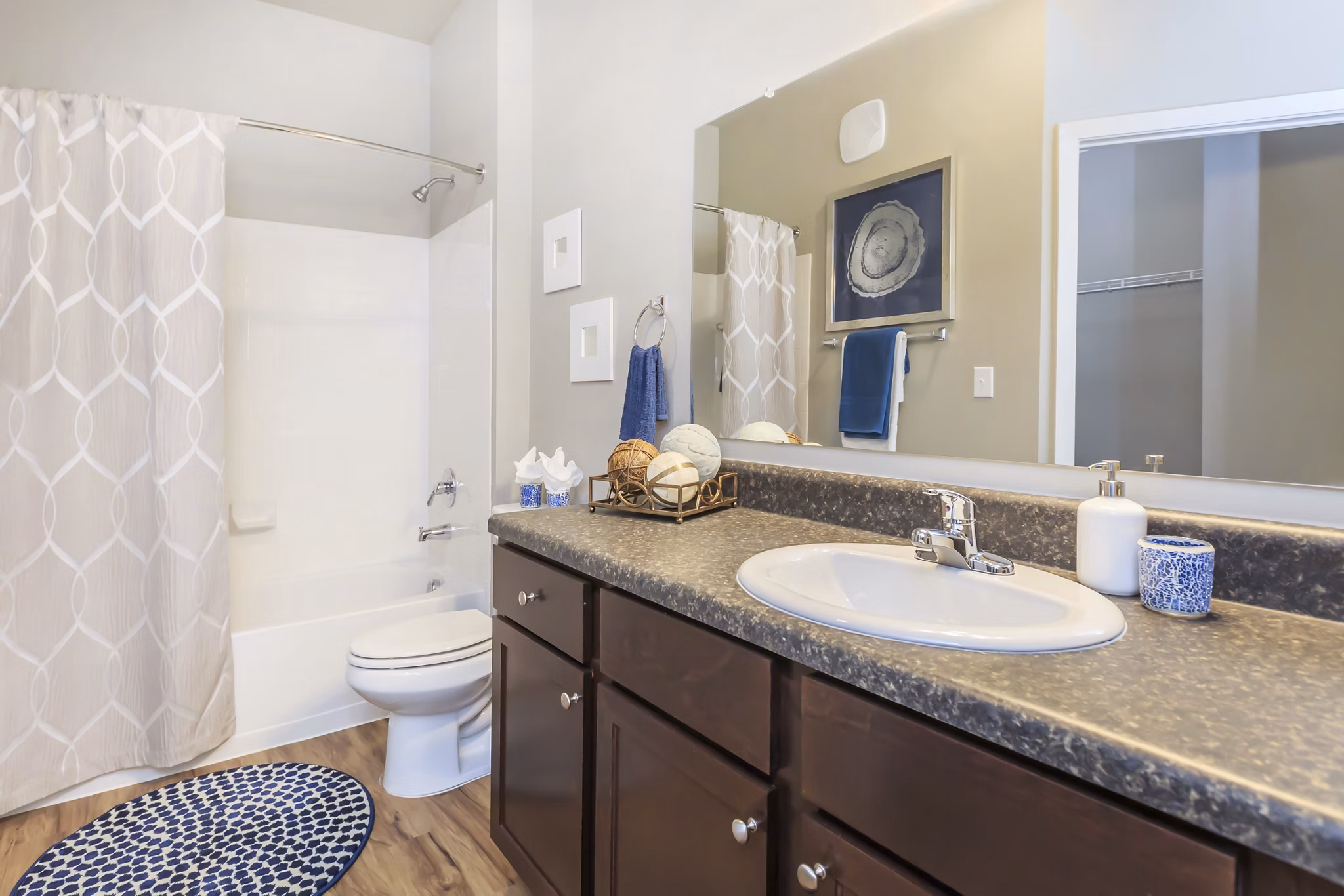 Bathroom featuring sleek fixtures and white cabinetry in Vantage at Boerne Apartments