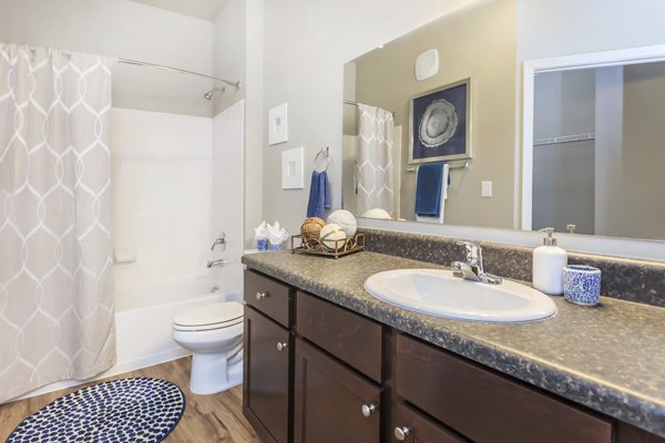 Bathroom featuring sleek fixtures and white cabinetry in Vantage at Boerne Apartments