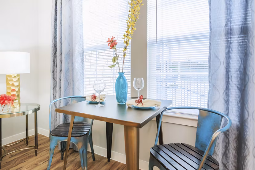 Dining room with modern decor and large windows at Vantage at Boerne Apartments