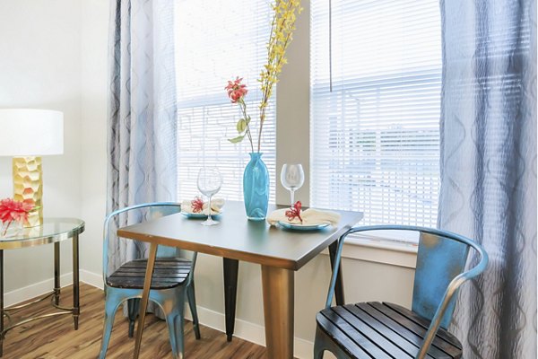 Dining room with modern decor and large windows at Vantage at Boerne Apartments