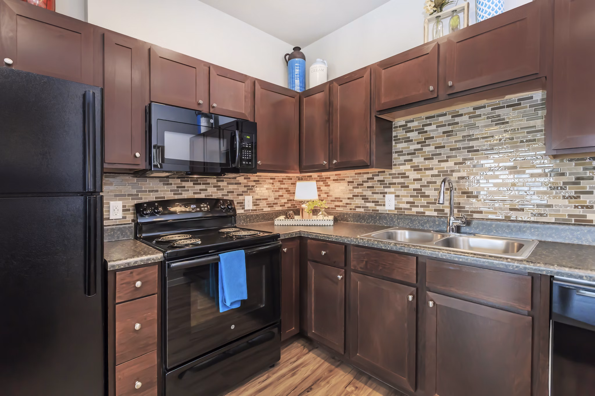 Modern kitchen with stainless steel appliances at Vantage at Boerne Apartments