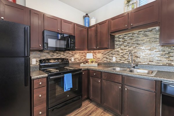 Modern kitchen with stainless steel appliances at Vantage at Boerne Apartments