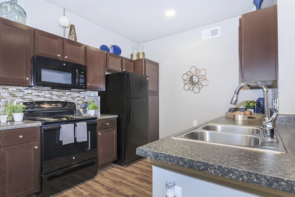Modern kitchen with stainless steel appliances at Vantage at Boerne Apartments