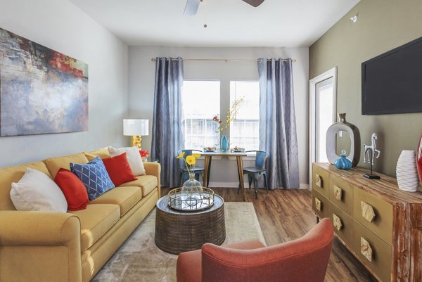 Expansive living room with modern decor at Vantage at Boerne Apartments, featuring stylish furniture and ample natural light