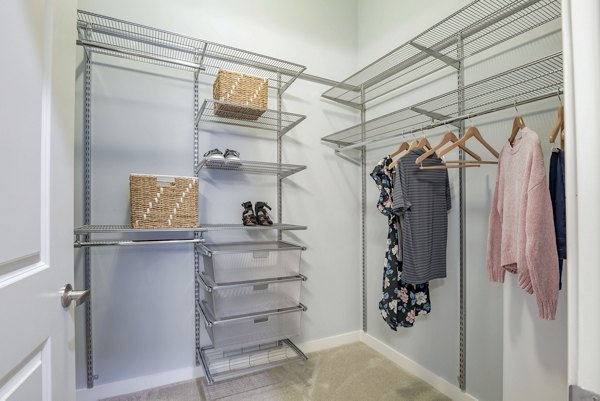 Walk-in closet with ample shelving in Aston City Springs Apartments