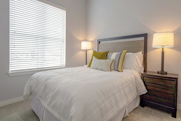 Cozy bedroom with modern furnishings at Aston City Springs Apartments
