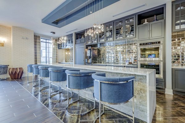 Clubhouse with contemporary design at Aston City Springs Apartments featuring luxury amenities and comfortable seating options