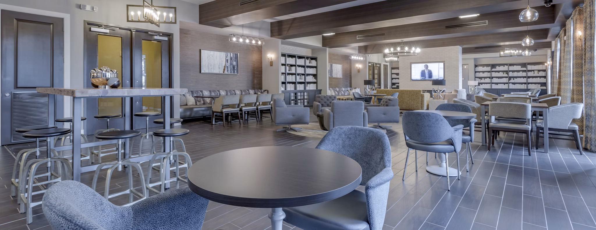 Clubhouse with contemporary decor and seating at Aston City Springs Apartments