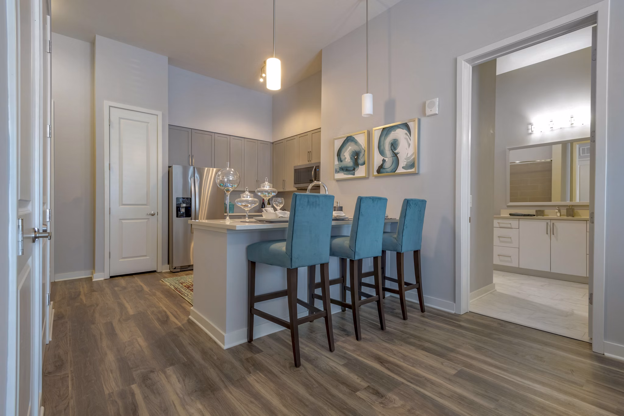 Dining area with modern furnishings at Aston City Springs Apartments, featuring elegant lighting and sleek design elements