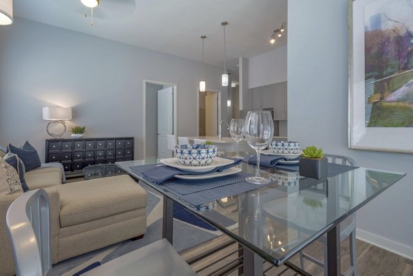 Dining area with modern furnishings at Aston City Springs Apartments featuring a stylish table and chairs for luxury living