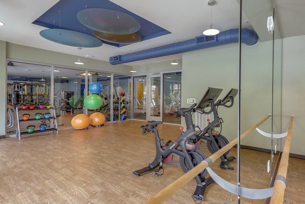 Yoga/spin studio with modern equipment at Aston City Springs Apartments