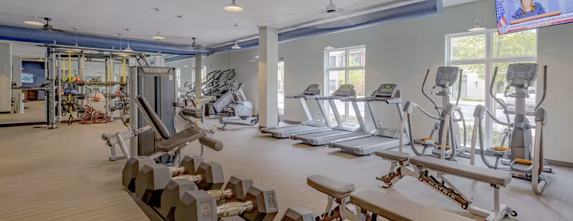 State-of-the-art fitness center at Aston City Springs Apartments featuring modern workout equipment and open exercise spaces
