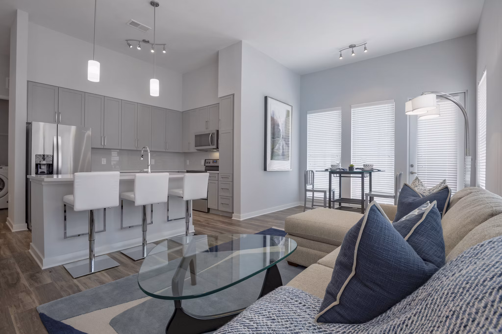 Modern living room with elegant furniture and abundant natural light at Aston City Springs Apartments
