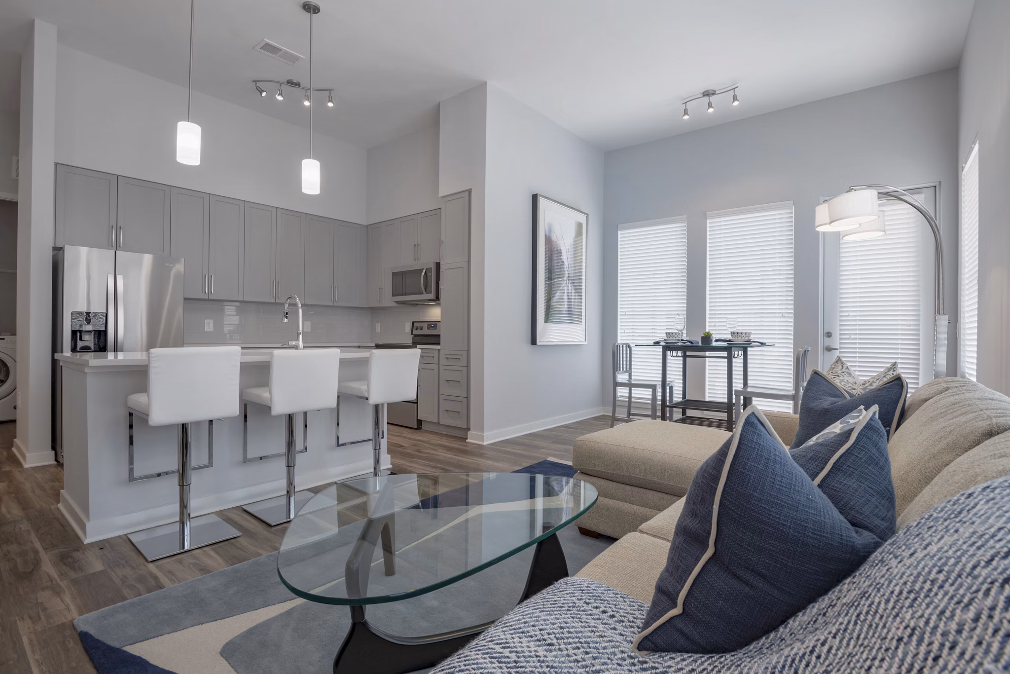 Modern living room with elegant furniture and abundant natural light at Aston City Springs Apartments