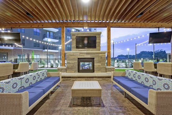 Courtyard garden at Aston City Springs Apartments featuring lush landscaping and seating areas